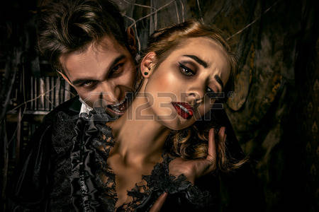 52917448-bloodthirsty-male-vampire-in-medieval-dress-is-biting-a-beautiful-lady-halloween